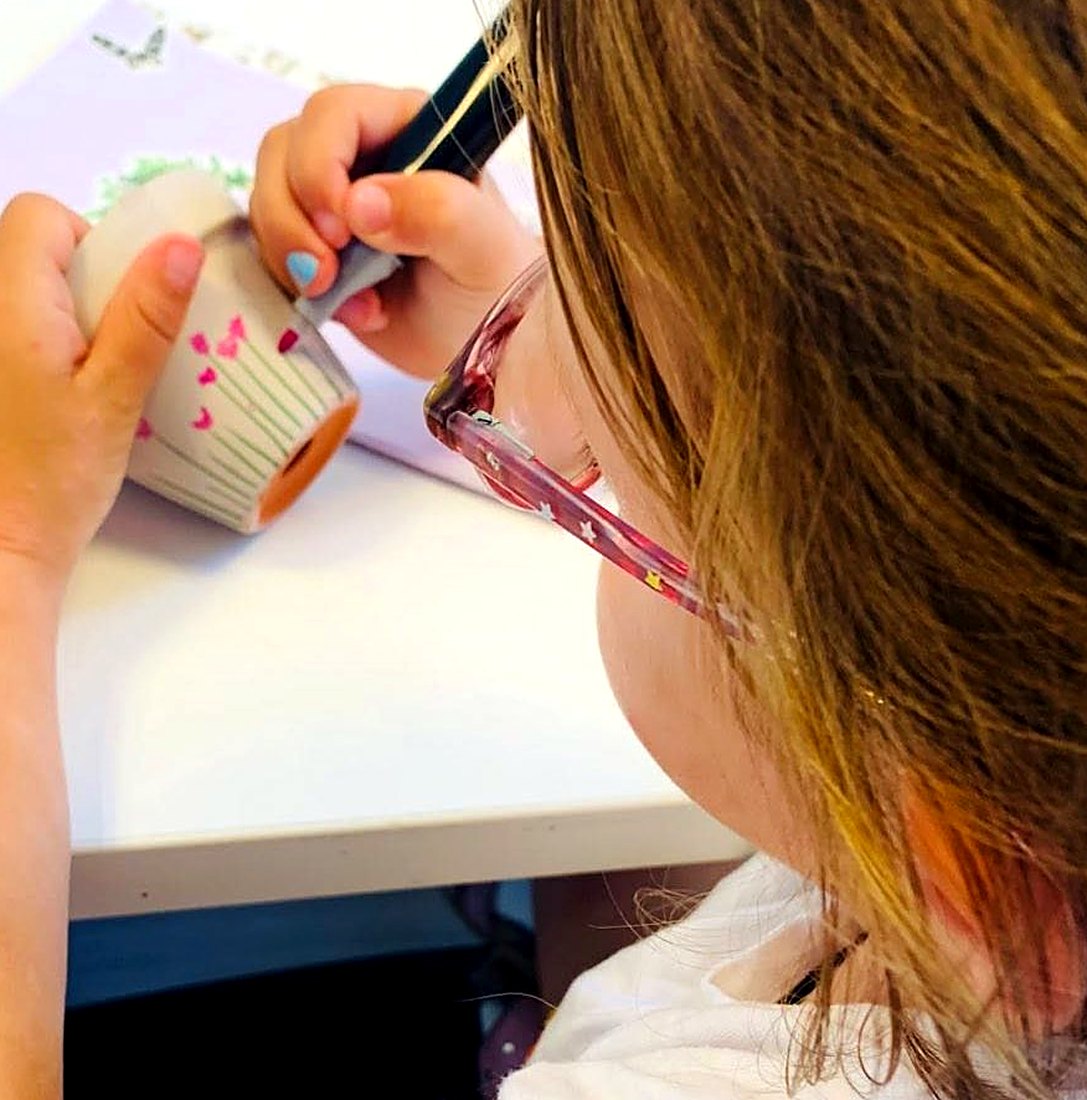 Painting her own pottery cup