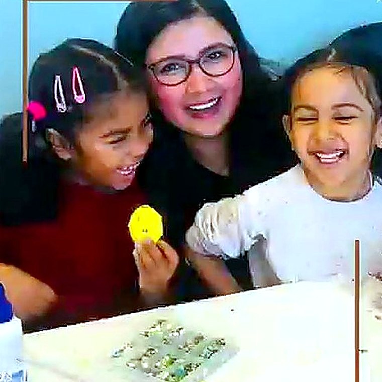 Ms. Praddy with children at Chalk & Duster