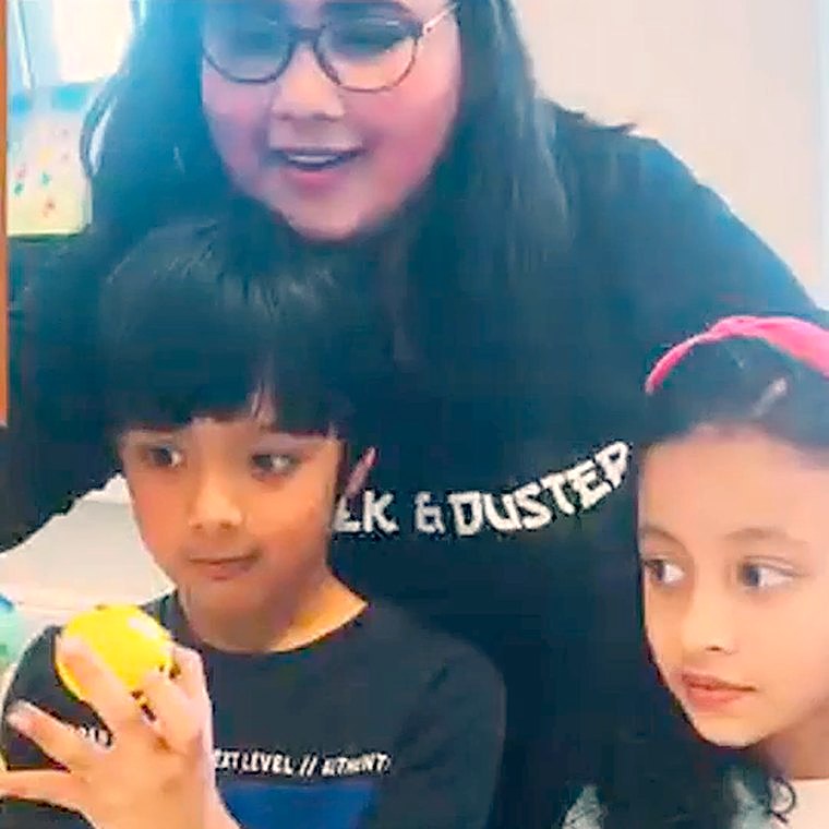 Ms. Praddy with children at Chalk & Duster